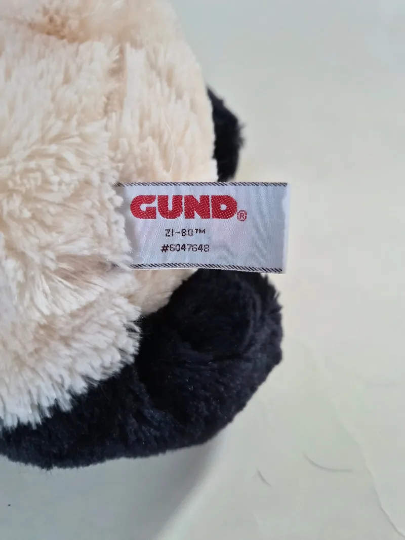 Close-up of the GUND fabric tag reading Zi-Bo #6047648 on the panda's cream fur