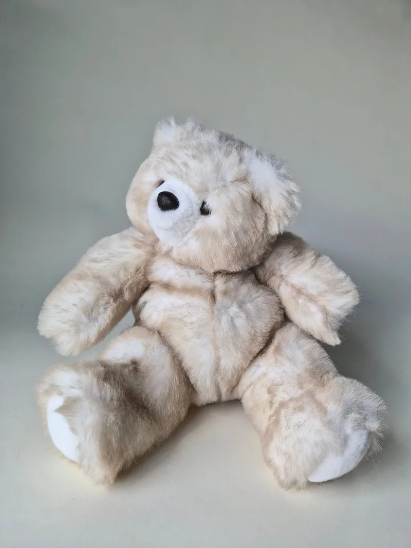 Frosted grey and cream teddy bear sitting upright, arms out, with a two-tone ivory muzzle and black stitched nose