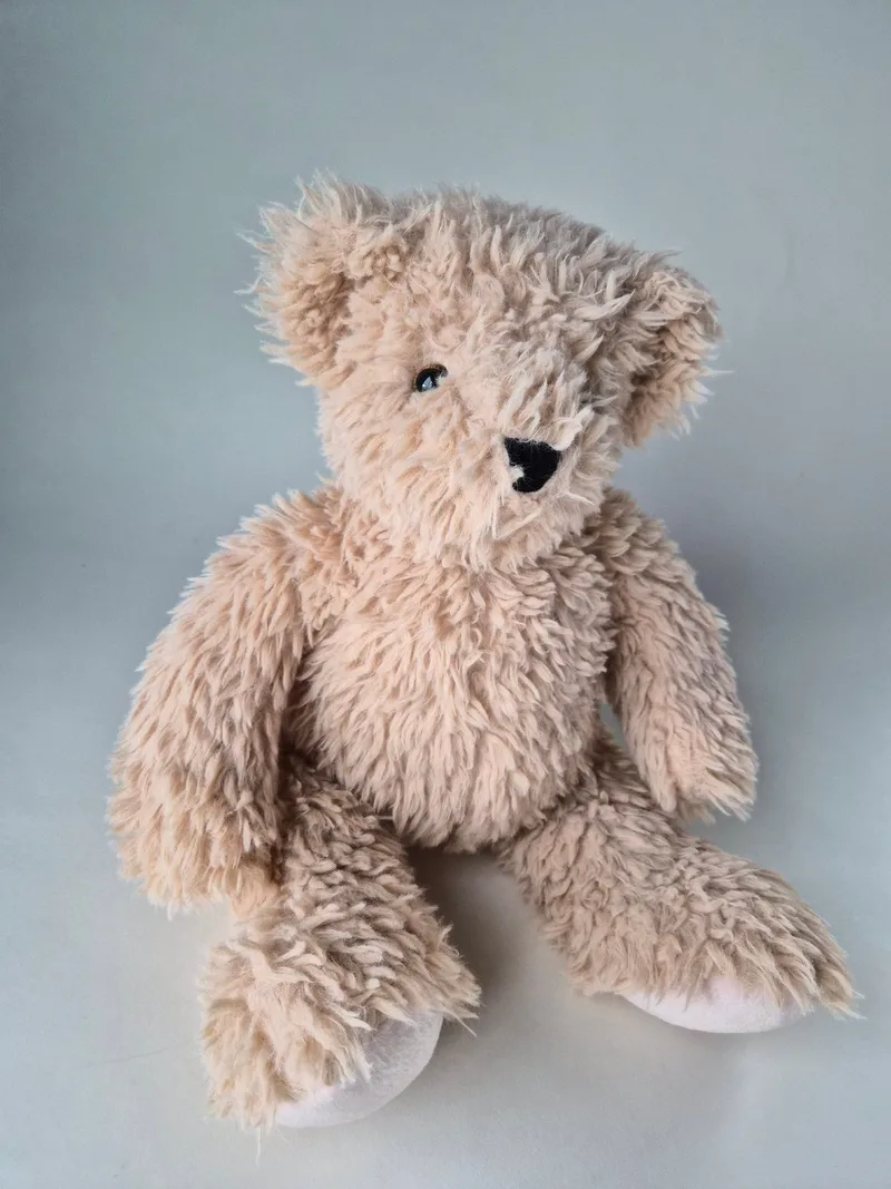 Front view of the honey-colored long-limbed teddy bear with ivory velvet foot soles and floppy arms