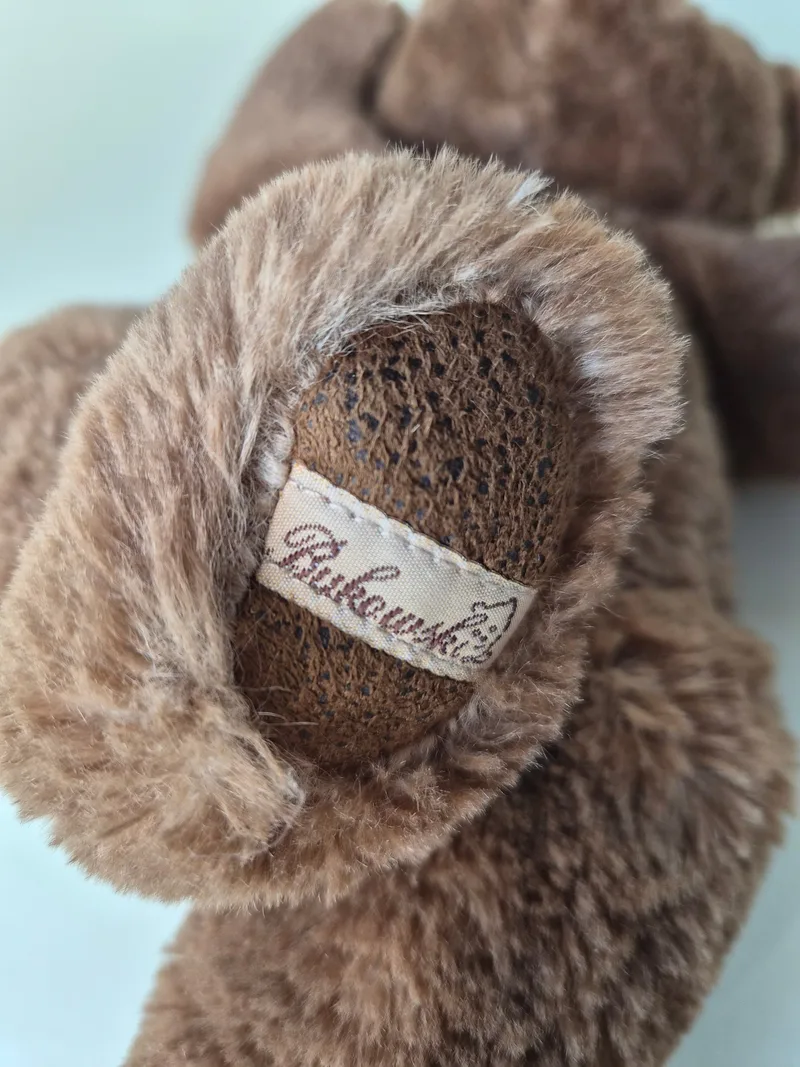 Bukowski belly label sewn into the seam among the bear's brown plush