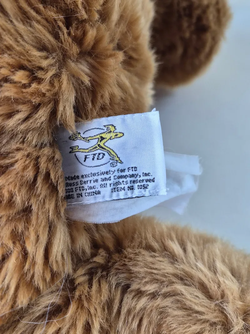 Sewn-in white fabric tag reading Made exclusively for FTD by Boss Berrie and Company, Made in China