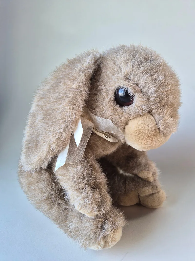 Commonwealth plush rabbit facing forward with sheer ivory neck ribbon and floppy ears