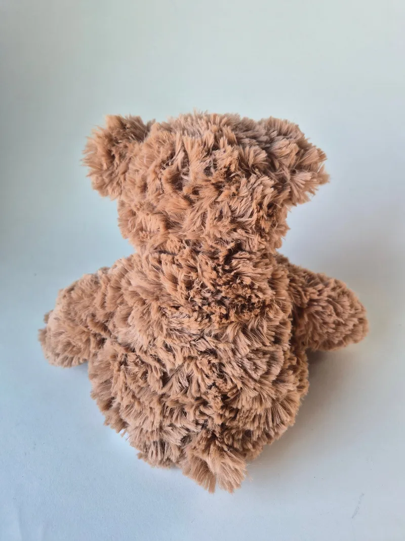 Back view of the tumbled toffee shag coat showing darker streaks and short ears