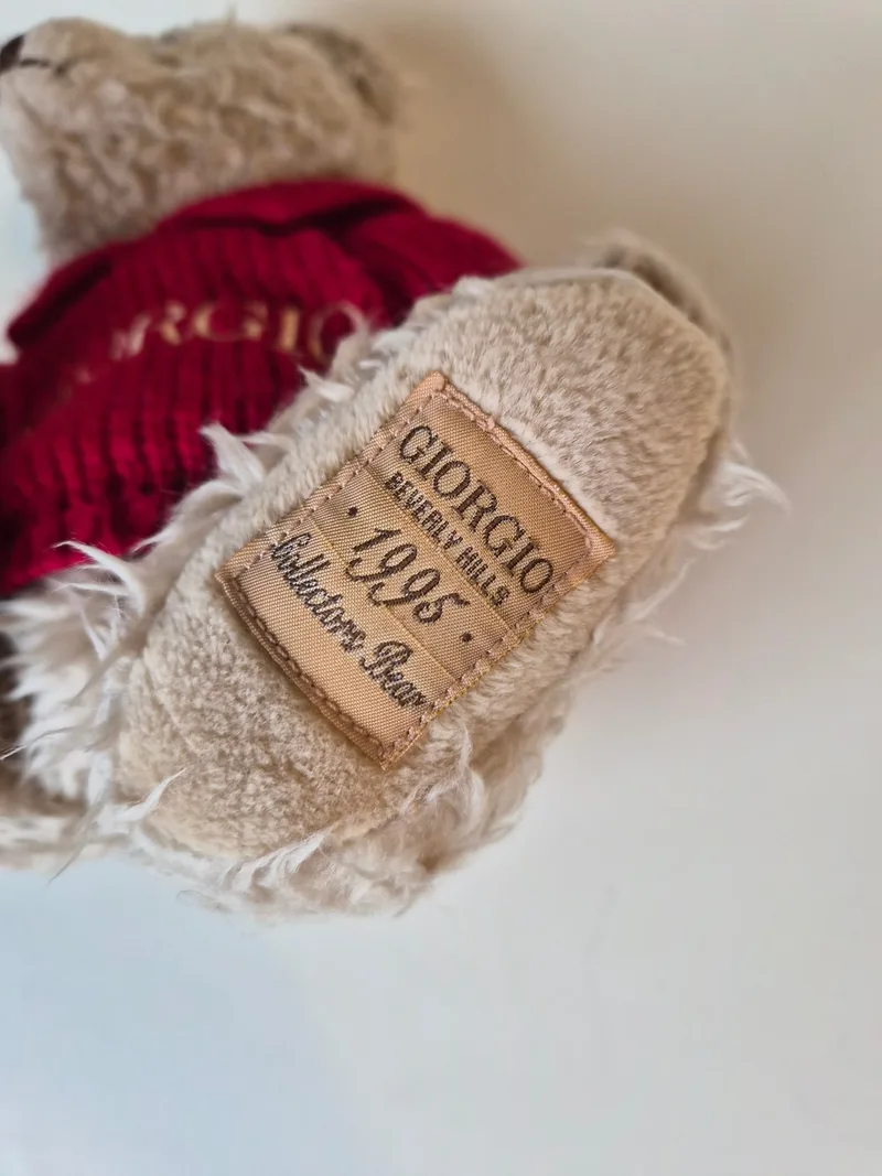 Close-up of the bear's foot tag reading Giorgio Beverly Hills 1995 Collector's Bear