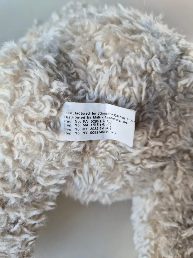 Fabric label at the bear's seam reading Manufactured for Schmidt-Cannon International, Distributed by Matrix Essentials, Inc.