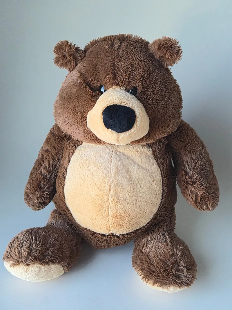 Large sable-brown teddy bear with a cream belly and muzzle, seated facing forward with arms out