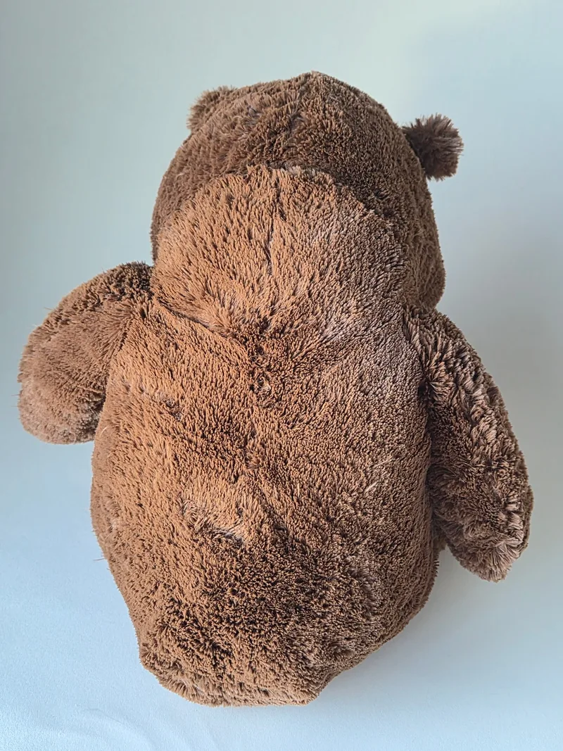 Back view of the brown bear showing dense fur and a center seam down the spine