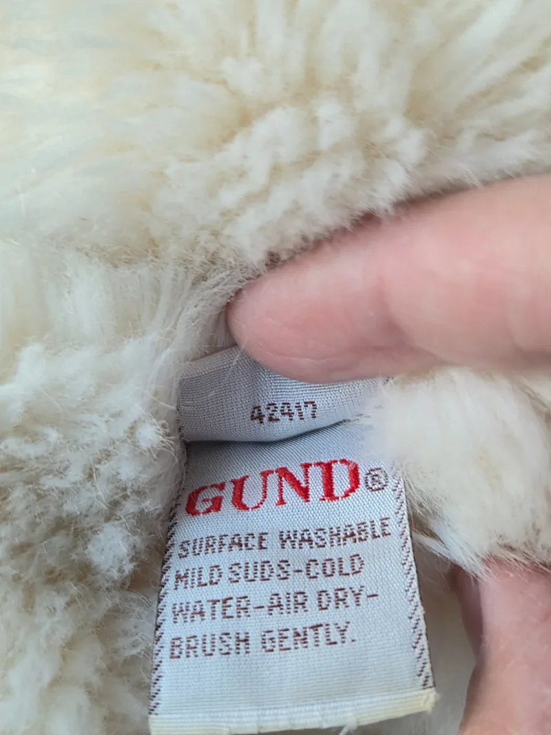 Close-up of the woven Gund care label reading 42417 with red washing instructions