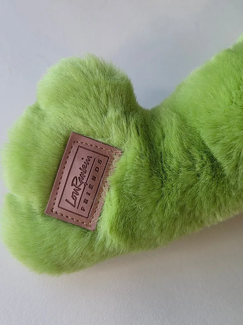 Close-up of the frog's left foot with an embossed leather patch reading Lou Rankin Friends