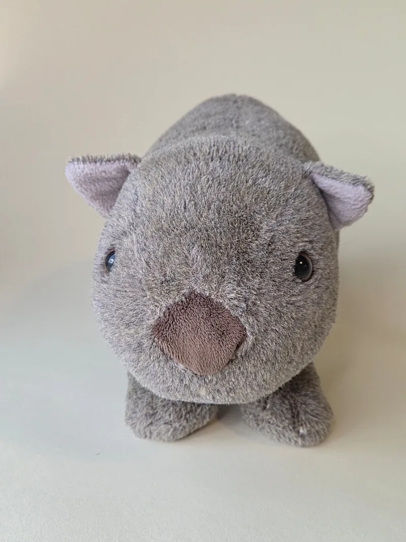 Front view of grey plush wombat with suede muzzle and two bead eyes