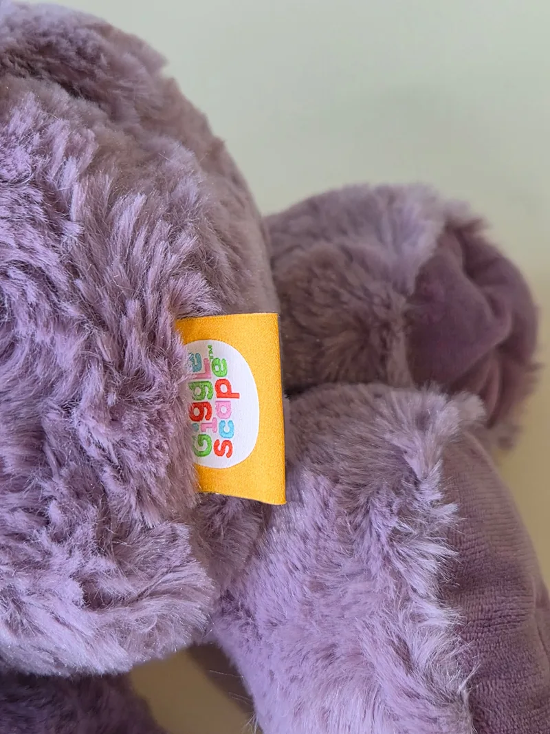 Close-up of the orange GiggleScape woven tag on the bear's back