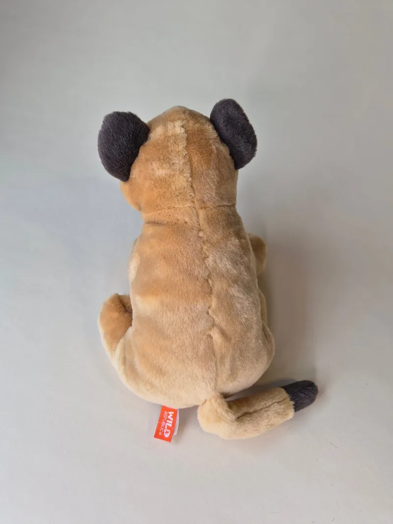 Back view of the lion cub plush showing the fur seam down the spine and a red-orange Wild Republic fabric tag.