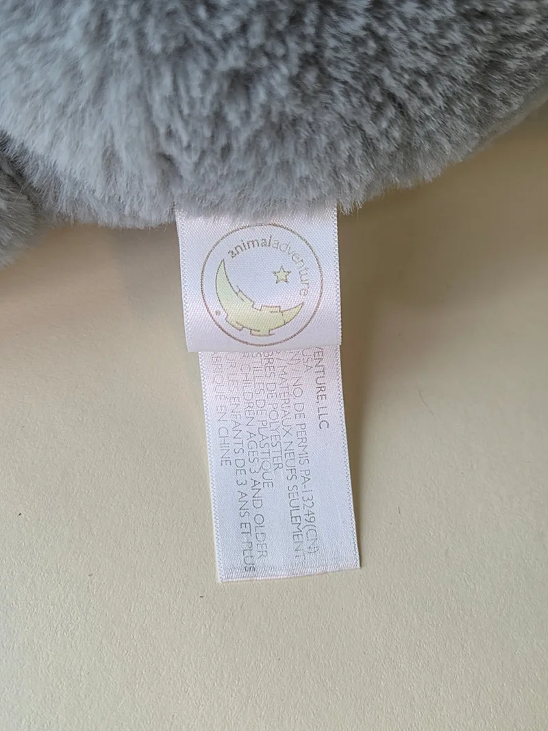 Close-up of the Animal Adventure fabric tag with moon-and-star logo