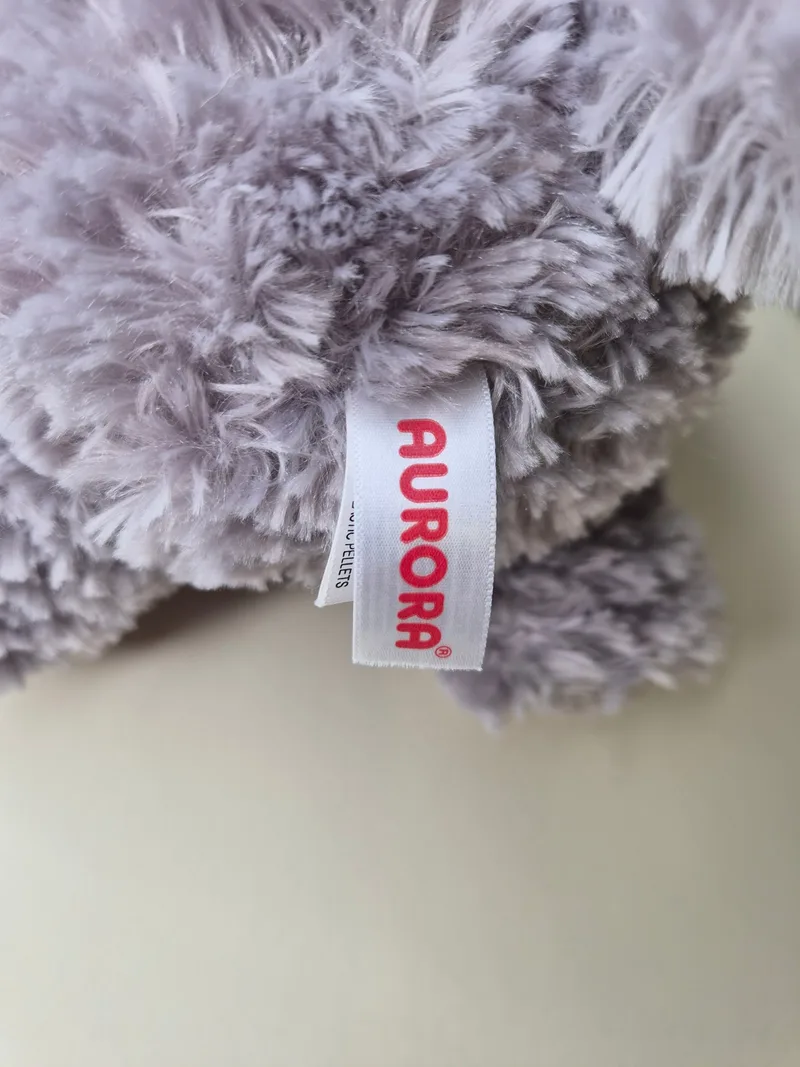 Close-up of the Aurora maker's tag stitched into the fur at the back seam