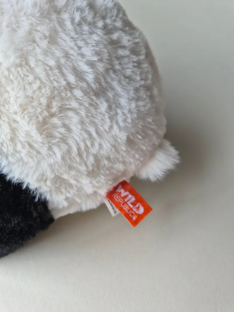 Close-up of the orange Wild Republic tag stitched into the fur seam