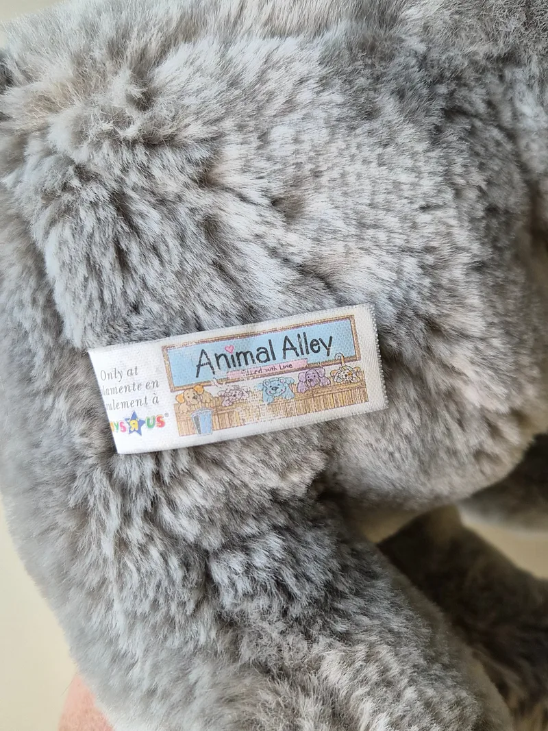 Close-up of woven Animal Alley tag stitched into the elephant's back seam