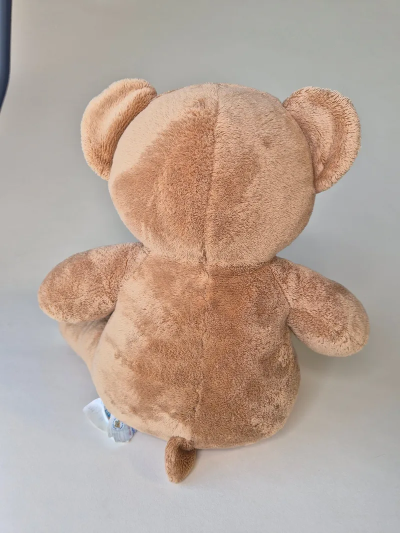 Back view of the same teddy bear showing the center back seam and short tail